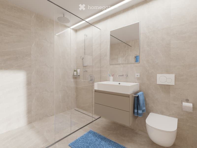 large tiled wall, white basin, mirror, shower area, floor drain, toilet, and towel rack