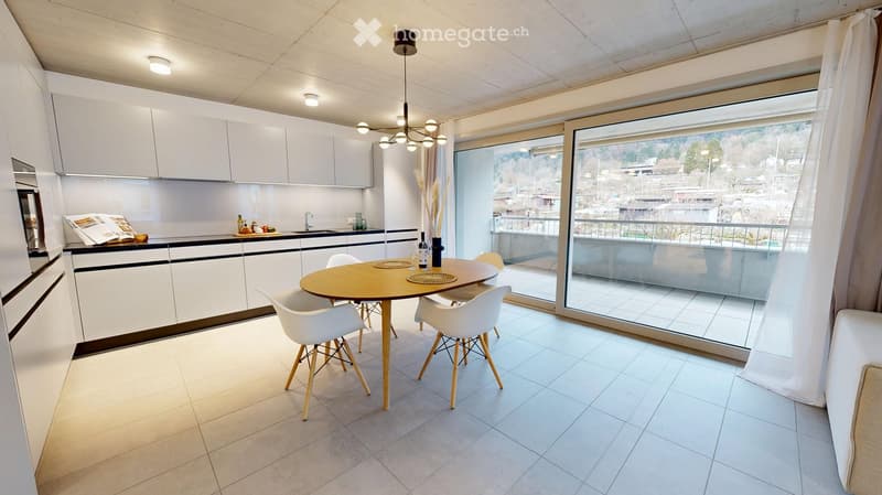 Modern kitchen with white cabinetry, a dining table with 4 chairs, and sliding glass doors to a balcony.