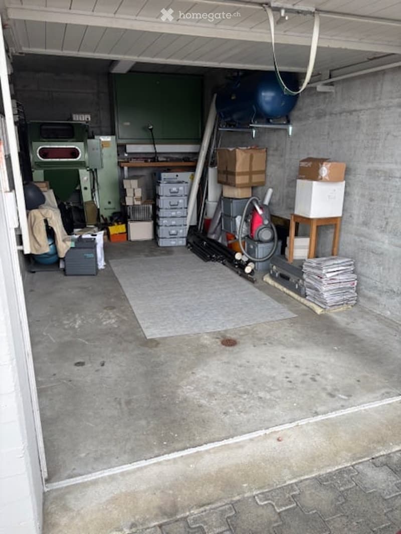 concrete floor, storage boxes, vacuum, empty space