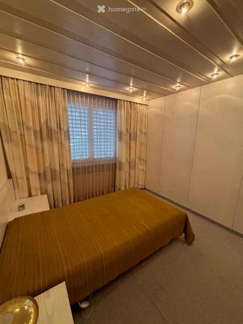 single bed, bedsheet, wooden bedside table, white wall, window, white curtains, recessed lighting