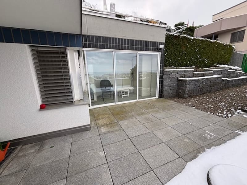 tiled terrace, glass sliding doors, brick walls, office chair, small table, view