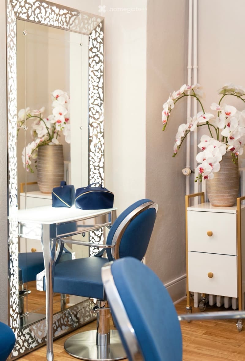 interior design, mirrors, blue chairs, white table, vases with white flowers
