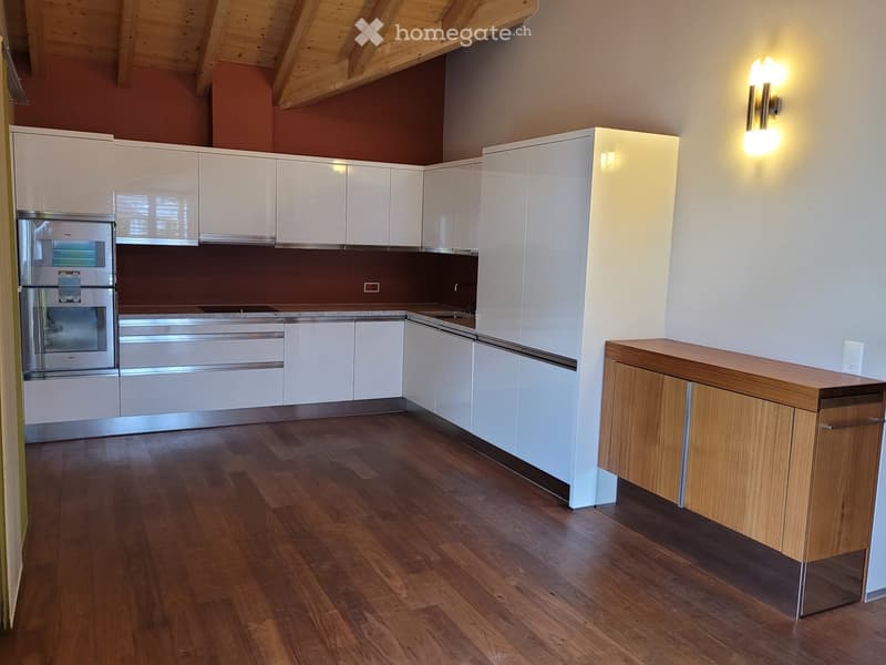 Modern kitchen with white cabinets, stainless steel appliances, wooden flooring, open layout, red wall, wooden ceiling, wooden cabinet