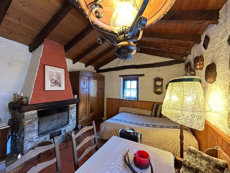Fireplace, bed, lamp, chair, table, cabinet, wooden ceiling, picture frame, wall decorations