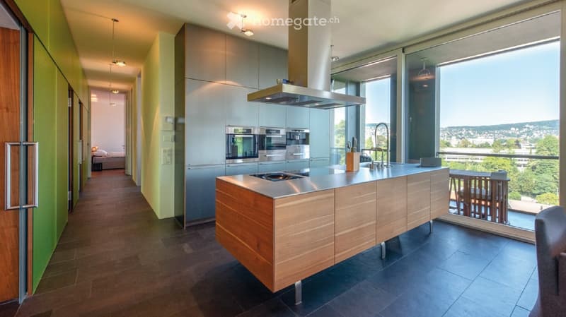 central kitchen island with stovetop, kitchen hood, sink, countertop, built-in appliances