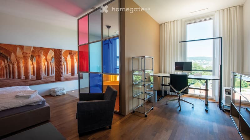 Bedroom with bed and chair, office desk with computer, large window, colored wall glass panel, desk, modern furniture