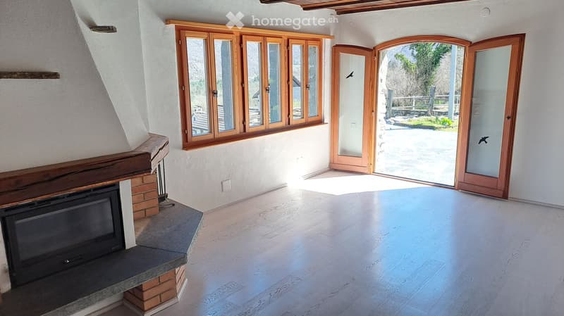 Fireplace, wooden windows, wooden doors, white walls, wooden floor