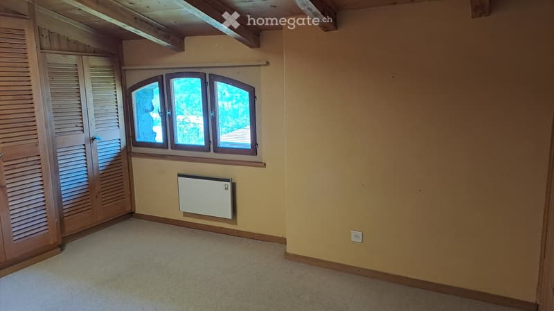 empty room, wooden ceiling, wooden wardrobe, beige walls, white floor, window with view