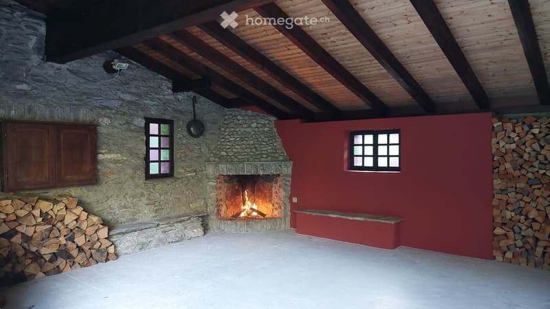 Fireplace, wooden benches, stone wall, window, ceiling