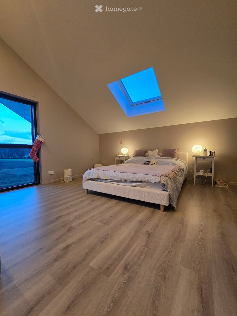 bedroom, wooden floor, large glass window, sky light, bed with pillows, bedside tables with lamps