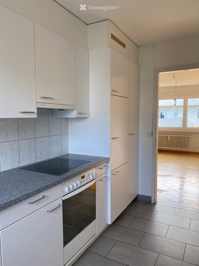 white cupboards, tiled backsplash, oven, countertop, granite countertop, radiator