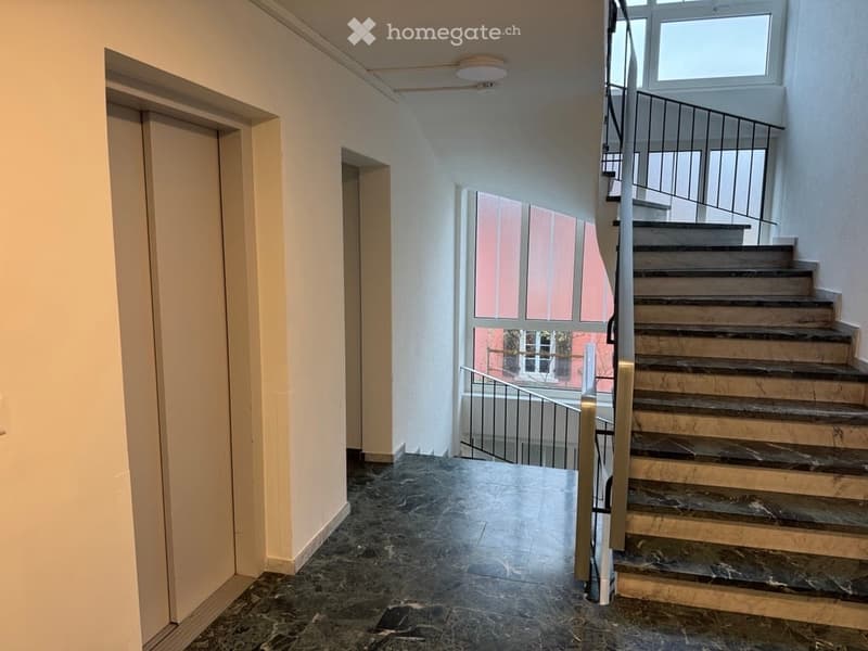 marble floors, stone steps, elevator, window, hallway with access to another building