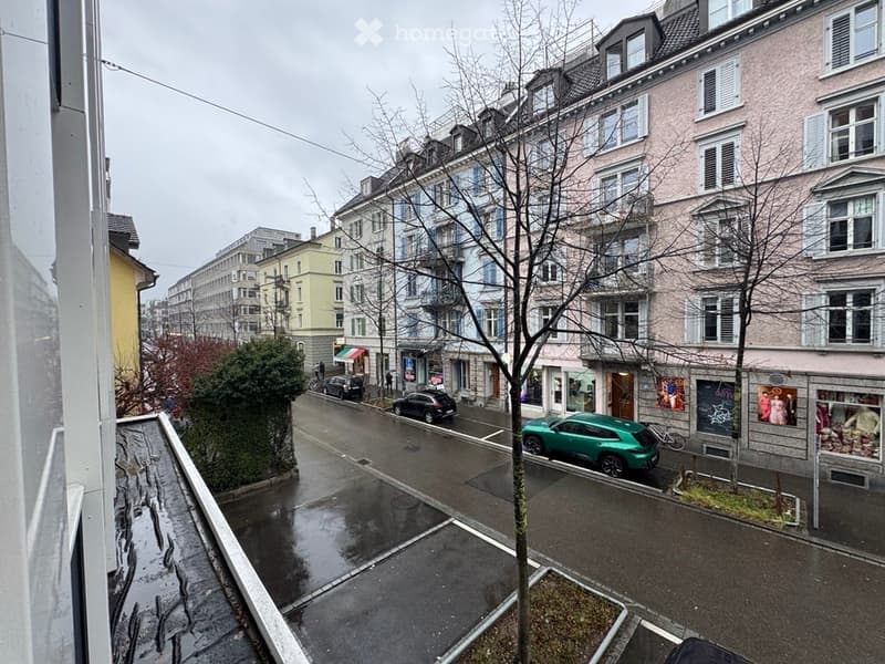 balcony view of street with parking space in front of building