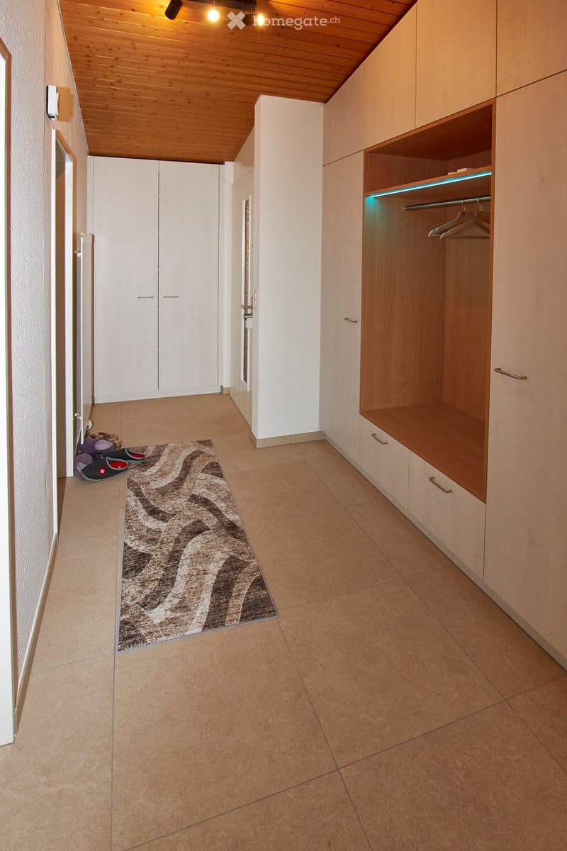 wooden ceiling, built-in wardrobes, tiles on the floor, rug