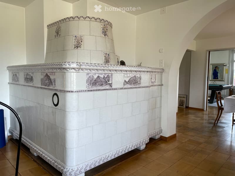 large fireplace, tiled, white walls, wooden floors