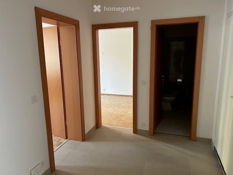 empty room, wooden doors, tiled floor, light colored walls