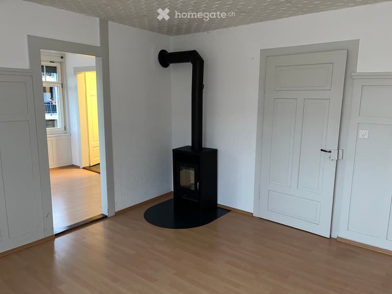 empty room, fireplace, wooden floor, white walls, two doors