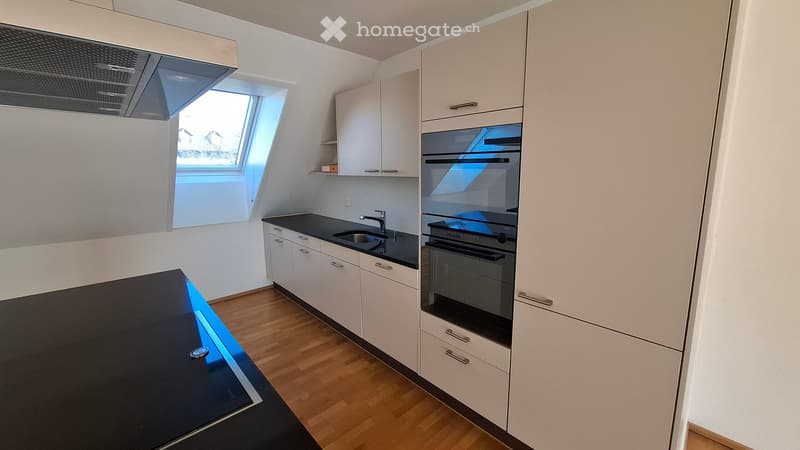 modern kitchen with double oven, granite countertop, dishwasher, white cabinets, window