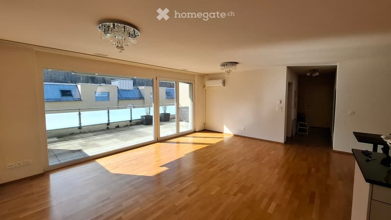 wooden floor, large windows, sliding glass doors to terrace, chandeliers, balcony with potted plants