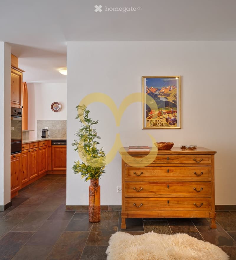 wooden cabinets, black tiled floor, white counter, wooden dresser, decorative plants