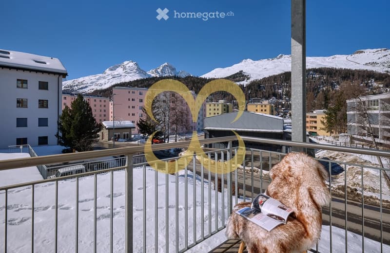 Snow-covered area, steel railing, building balcony, magazine on the chair, mountainous landscape