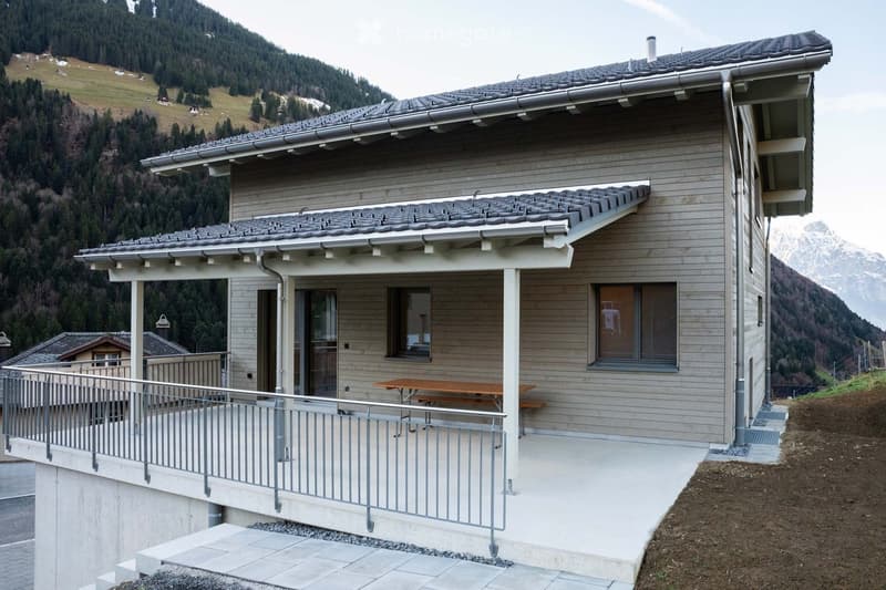 2 story house, wooden exterior, concrete floor, balcony, grey roof