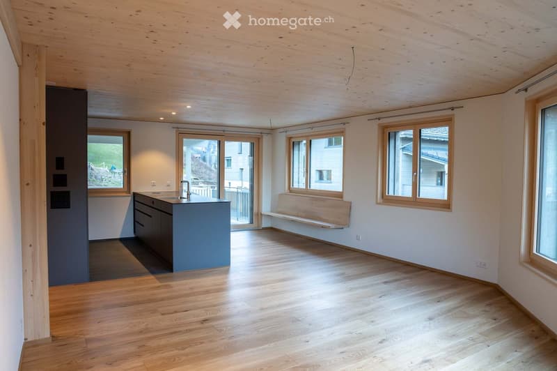 Open concept room with kitchen, window, wood bench, hardwood floor