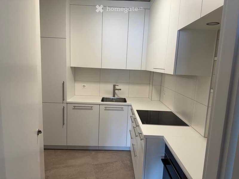 Kitchen with cabinets, stove, sink, faucet, power outlet