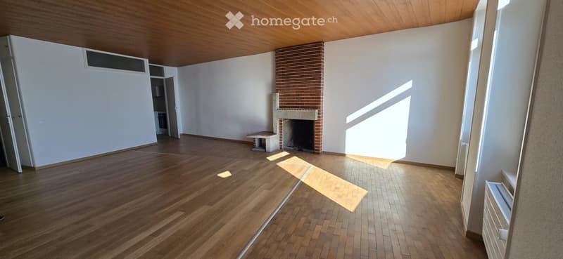 hardwood floor, fireplace, two windows, white walls