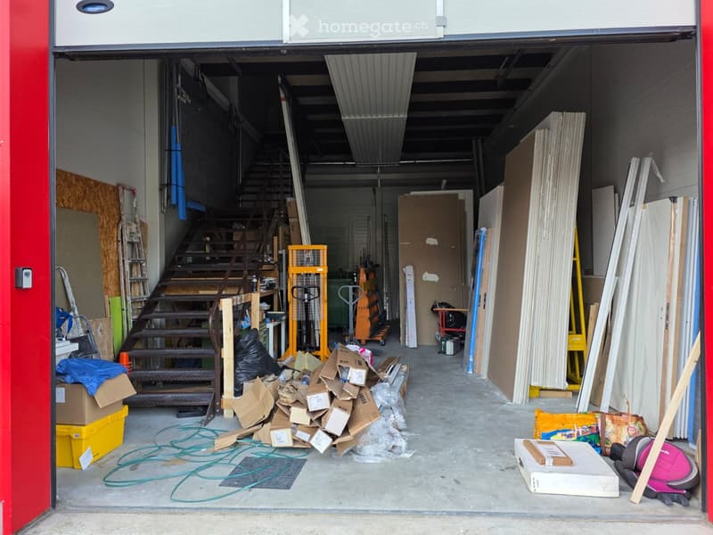 Storage room with stairs, stacked materials, equipment and miscellaneous items