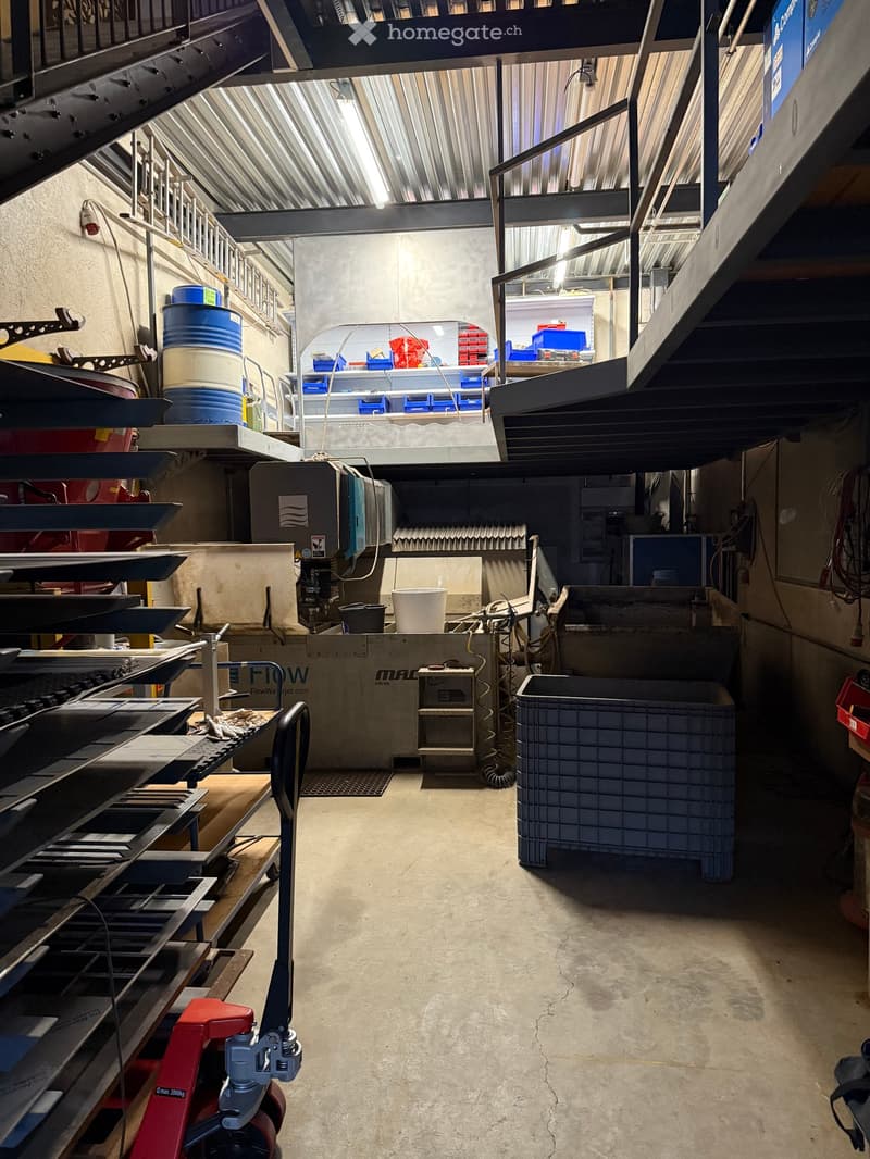 storage room with industrial equipment, shelving, and storage bins