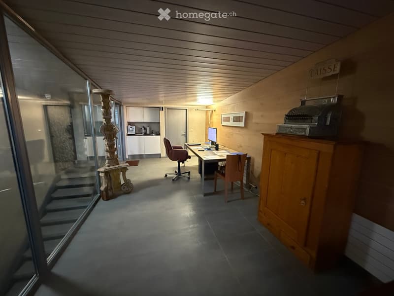 room with wooden cabinet, office chairs, desk with computer, glass walls