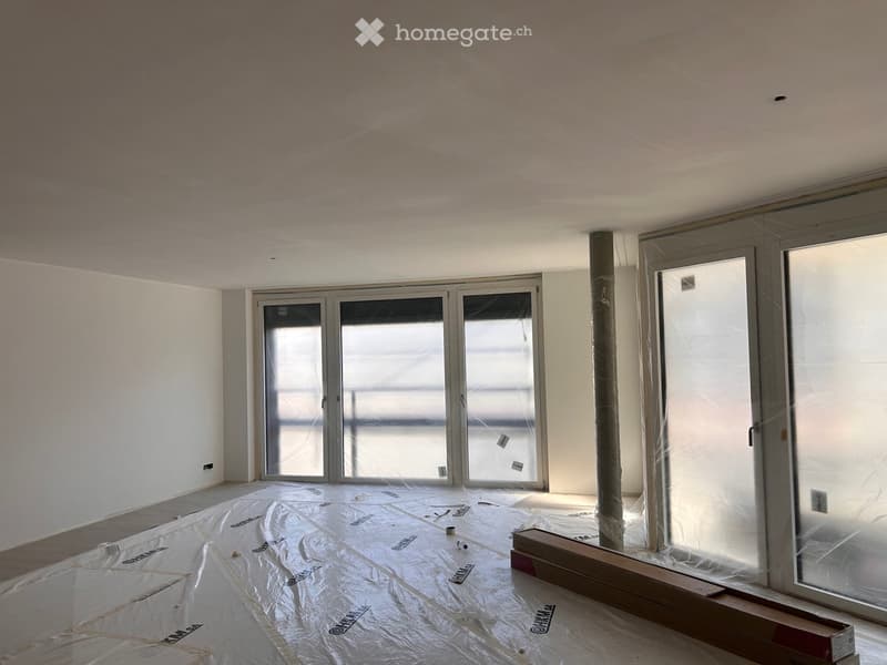 empty room, white walls, large windows, tarpaulin on the floor