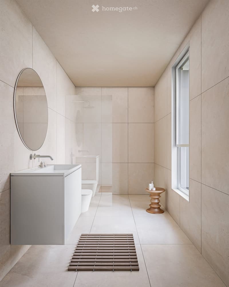 modern bathroom with white countertop, round mirror, toilet, shower, and small window