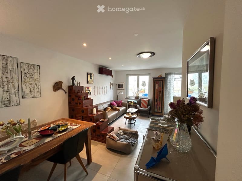 Dining area with a table and chairs, flower vase, decorative items, sofa, coffee table, side table, window, potted plant, shelf with figurines, mirror, curtains