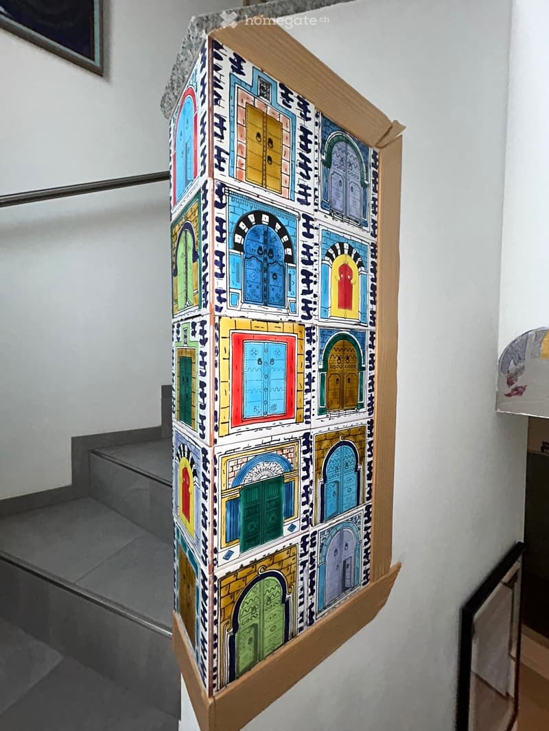 Staircase wall with multi-colored painted doors pattern