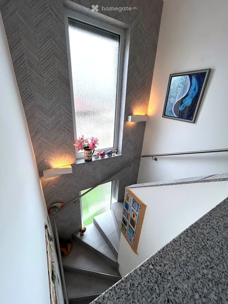 marble staircase, decorative tiles, large window, handrail, wall decorations, lighting