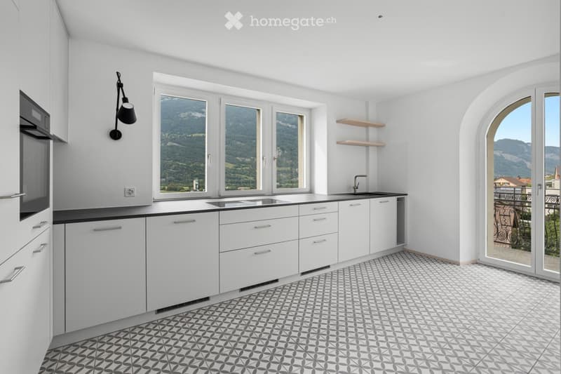 white cabinets, patterned flooring, large windows, modern appliances