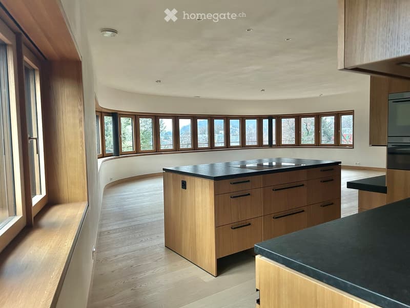 large kitchen island, wooden cabinetry, central heating, hardwood floors, multiple windows, gas stovetop