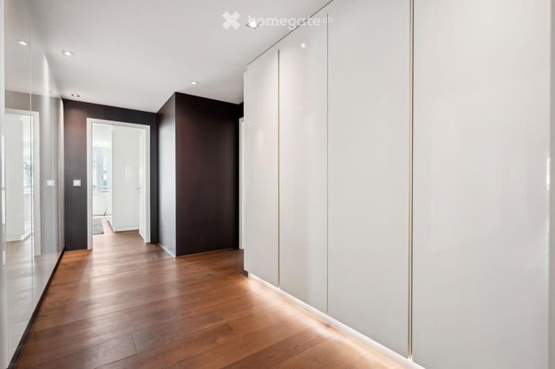 Hardwood floors, white walls, modern lighting, sliding doors