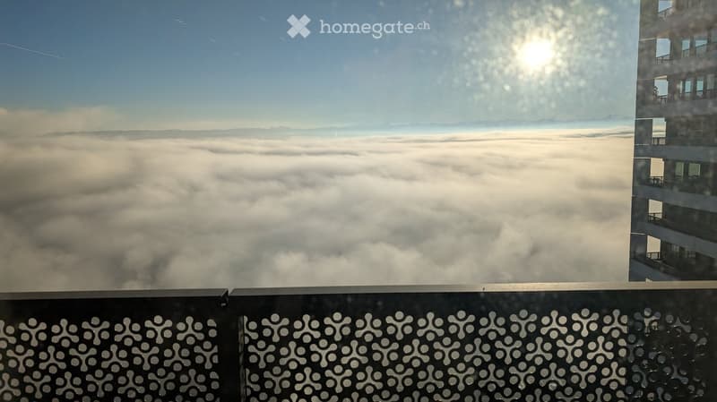 View from balcony/terrace, mountains, clouds, bright sun