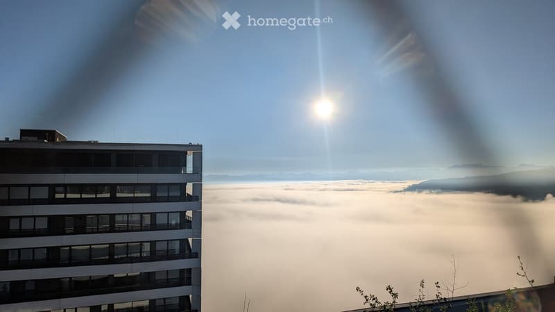 View from a window of a building looking over clouds