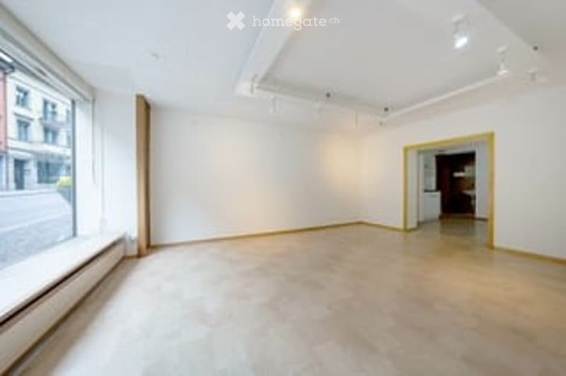 Empty room, white walls, wooden floor, large window, white ceiling, recessed lighting