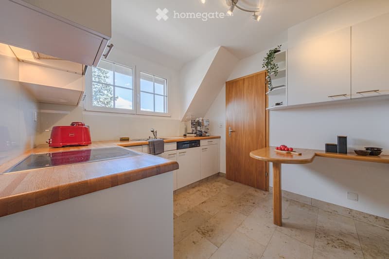 modern kitchen with white cabinets, wooden countertops, induction stove, dishwasher, toaster, sink, window