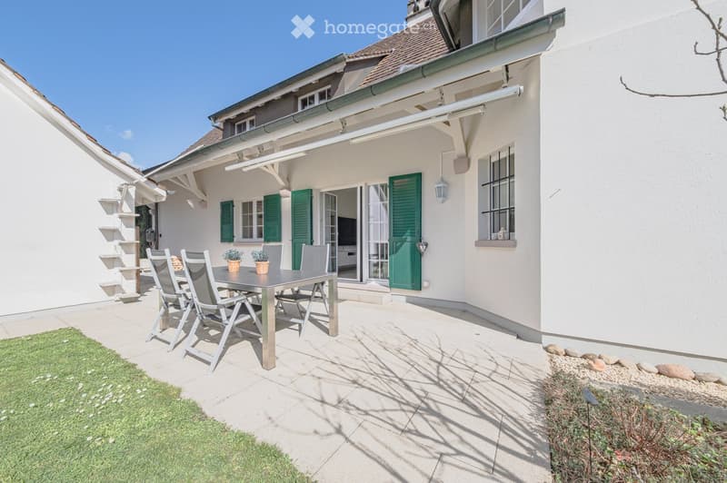 white house, green shutters, outdoor dining table, patio, lawn, garden