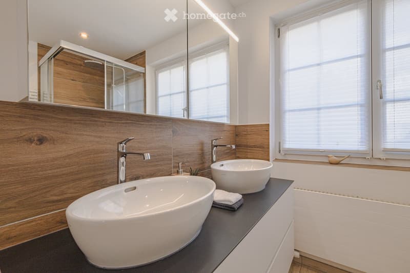 modern bathroom with two sinks, wooden wall, white tiles, shower, window with blinds