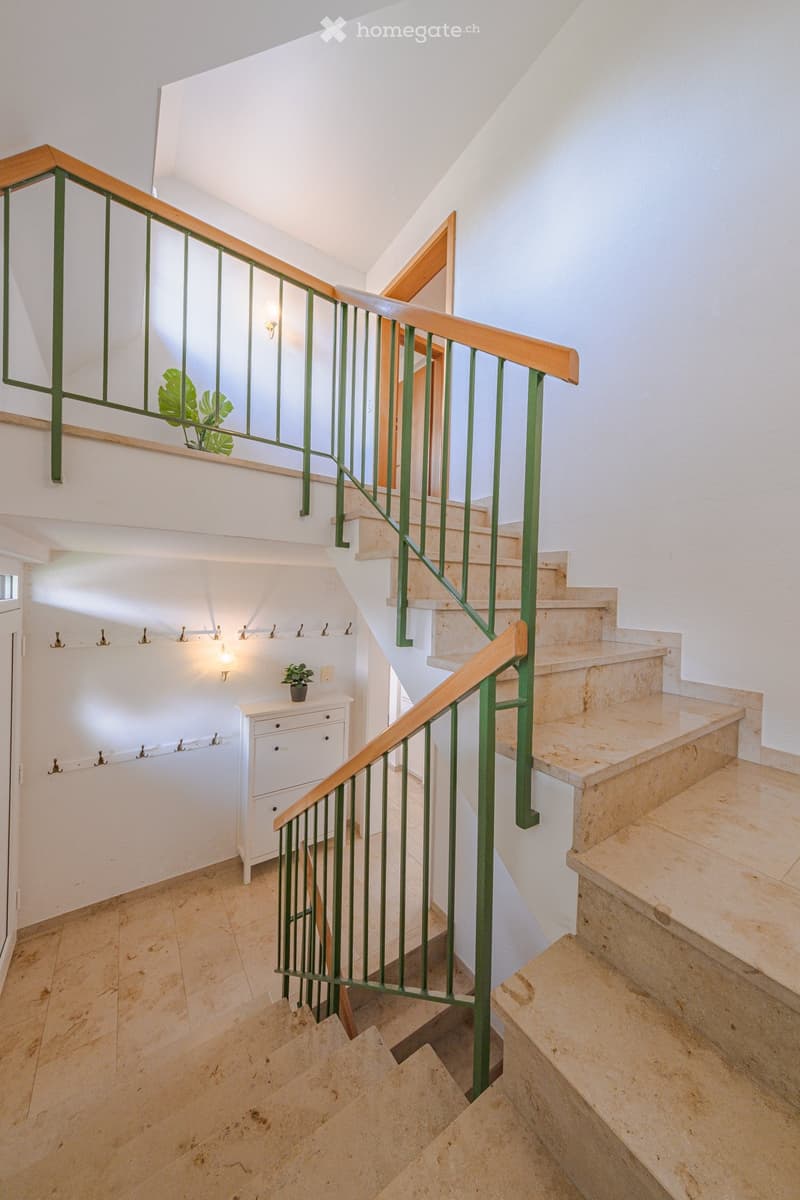 marble steps, green railings, white walls, wooden handrail, potted plants