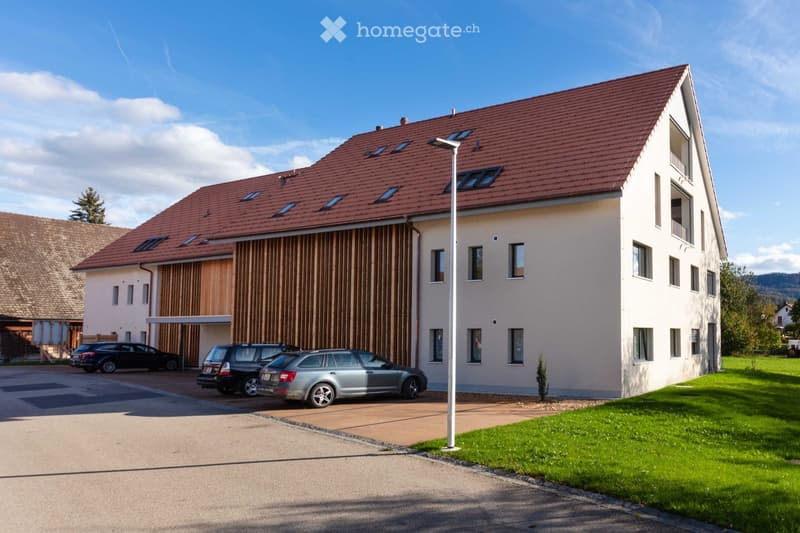 2 story house, white walls, brown roof, wooden wall, 3 cars parked in front