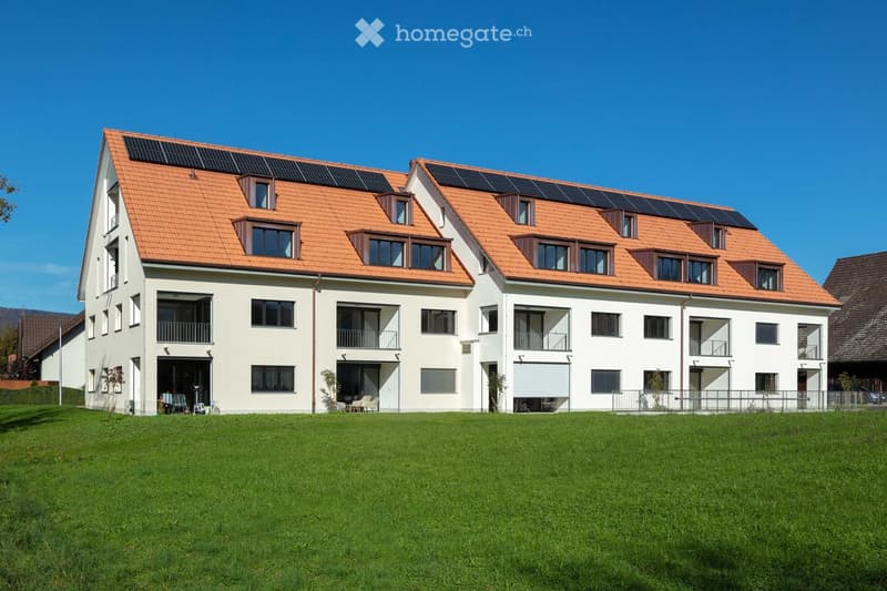 2 story house, white exterior, orange roof, solar panels, multiple windows, balconies, large lawn