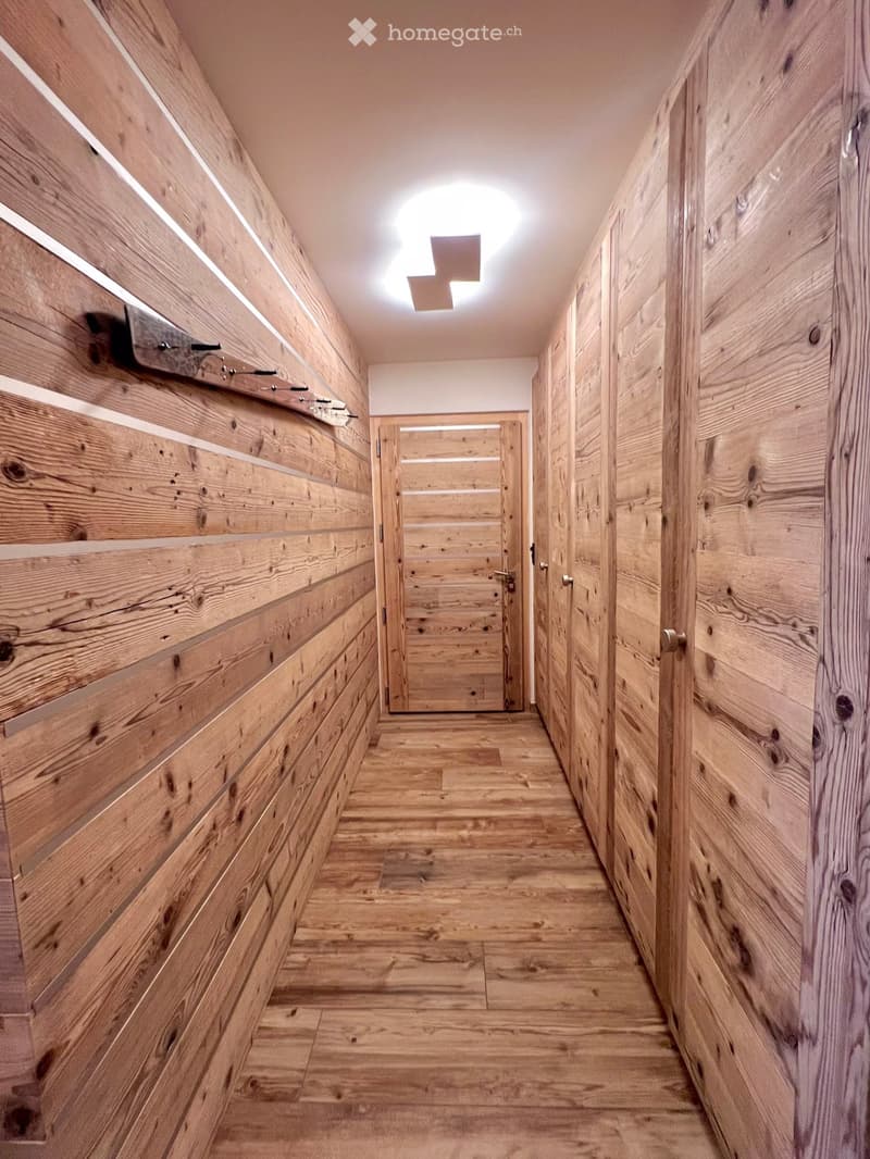 wooden walls, wooden floor, wooden doors, coat rack, ceiling light